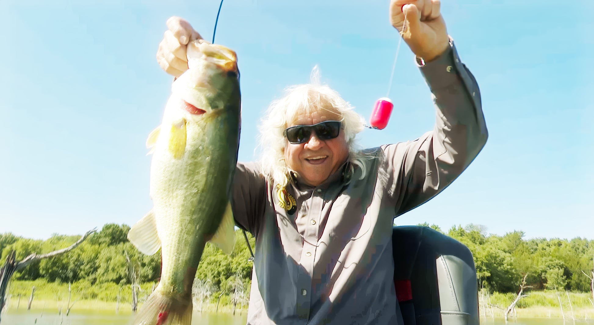 Angler holding a large bass with Bobba-Gamoochie bobber in hand